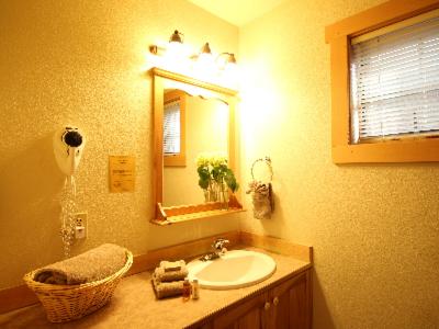 a bathroom with a sink and a mirror at River's Edge Resort in Winthrop