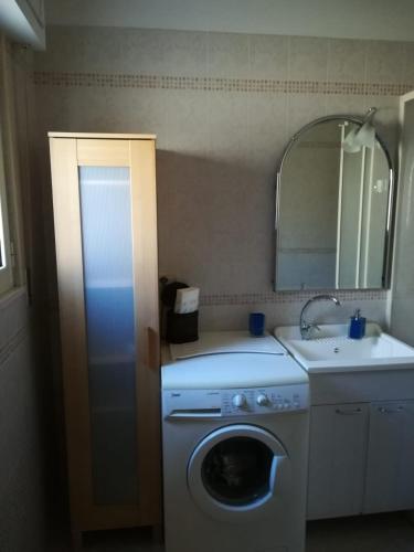 a bathroom with a washing machine and a sink at A casa di Bruna in Martella
