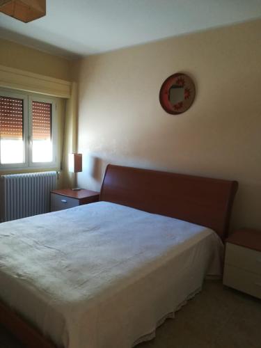 a bedroom with a bed and a clock on the wall at A casa di Bruna in Martella