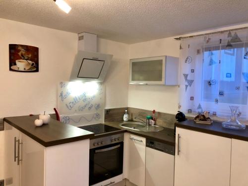 a kitchen with a sink and a stove top oven at " Sunshine am See " in Friedrichshafen
