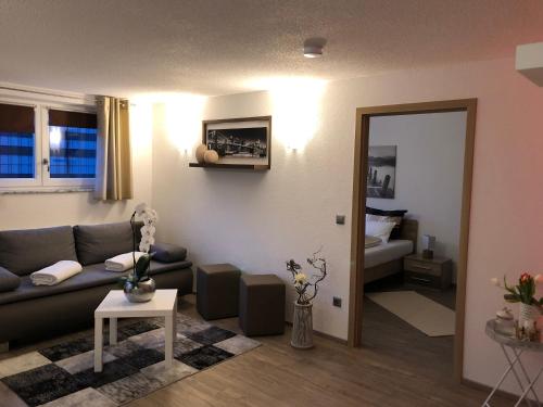 a living room with a couch and a table at " Sunshine am See " in Friedrichshafen