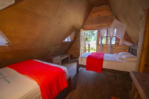 a bedroom with two beds in a room at Ecolodge & Villas Tziscao: Lagos de Montebello - Tziscao in Santiago