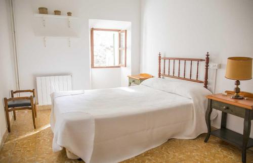 a bedroom with a bed and a table and a chair at Hiker's TownHouse in Sóller