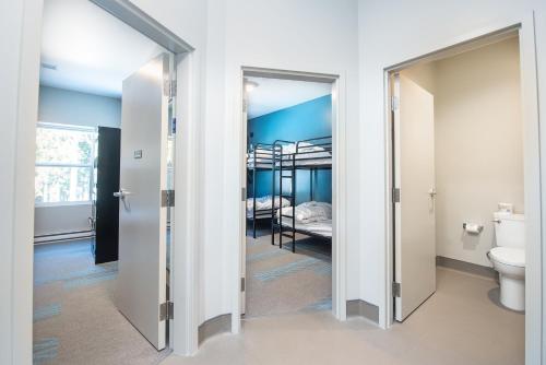 a bathroom with a door open to a bedroom with a bunk bed at Nowhere Special in Rossland