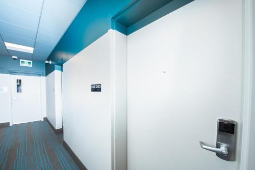 a hallway with a door in a office building at Nowhere Special Hostel in Rossland