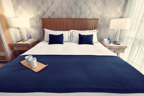 a bed with a white comforter and pillows at Artezen Hotel in New York