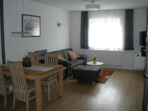 a living room with a couch and a table at Ferienwohnungen Flora in Bad Windsheim