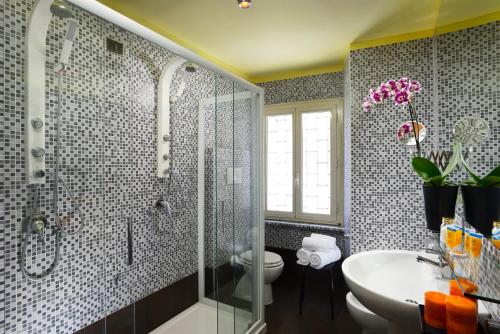 a bathroom with a shower and a toilet and a sink at Hotel Tuscolana in Rome