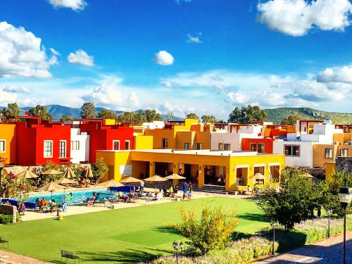 a group of buildings with a swimming pool and a resort at La Rosa House in San Miguel de Allende