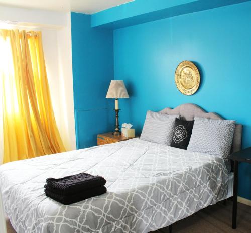 a bedroom with a large bed with blue walls at Artist in the Barn in Philadelphia