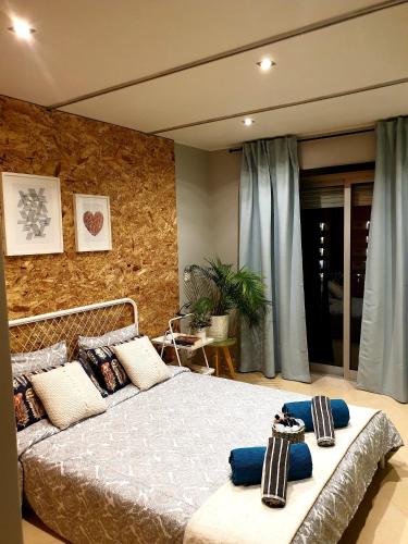 a bedroom with a large bed with blue pillows at SunHouse Room in Albufeira