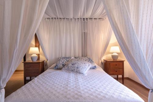 a bedroom with a canopy bed with two night stands at Torre di Badia in Badia A Passignano