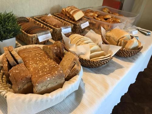 a table topped with lots of different types of bread at Hotel Flamingo in San Carlos de Bariloche