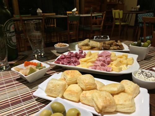 a table with plates of different types of food at Al Kamar Cabañas Lodge in Santa Ana