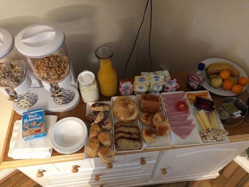 a table filled with different types of breakfast foods at bishop gate bnb in Derry Londonderry