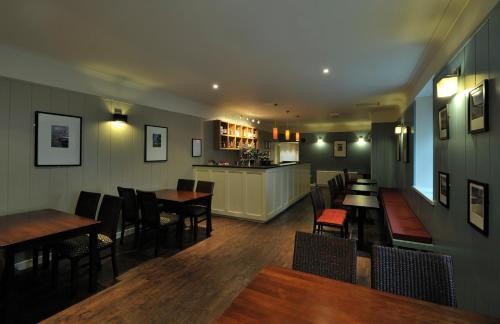 a restaurant with tables and chairs and a bar at St Clair Hotel in Thurso