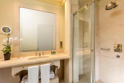 a bathroom with a sink and a shower at Hotel Casa Del Poeta in Seville