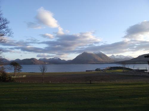 a view of a lake with mountains in the background at Raasay House Hotel in Raasay