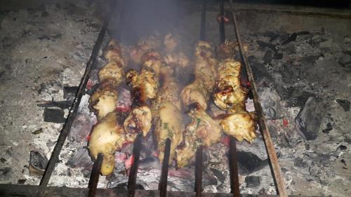 a group of chickens cooking on a grill at Ciao Hotel in Nuweiba