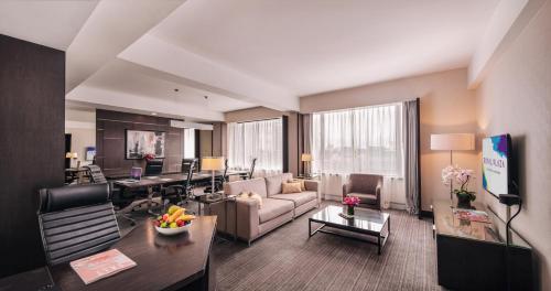 a living room with a couch and a table at Royal Plaza on Scotts in Singapore