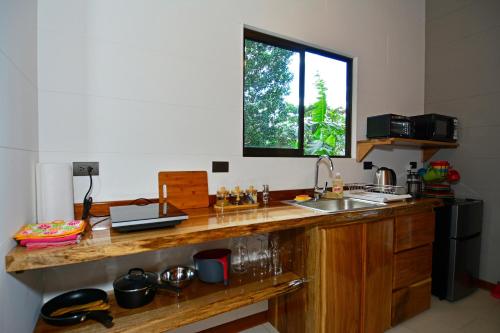 a kitchen with a wooden counter top and a sink at Aves de Tierras Altas in Bijagua