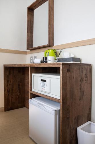 a kitchen with a white refrigerator and a mirror at Five hotel Jongno in Seoul