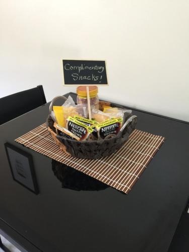a basket of food on a table with a sign on it at Squareville Subdivision in San Fernando