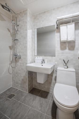 a bathroom with a white toilet and a sink at Five hotel Jongno in Seoul