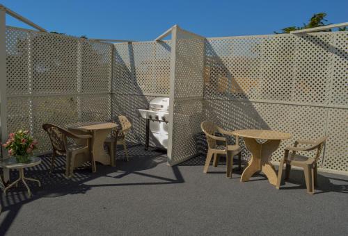 a patio with tables and chairs and a stove at Sea Breeze Inn - San Simeon in San Simeon
