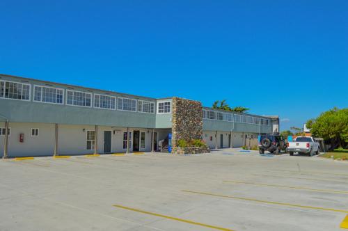a parking lot in front of a building at Sea Breeze Inn - San Simeon in San Simeon