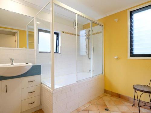 a bathroom with a shower and a sink at Straddie Beach House 2 in Point Lookout