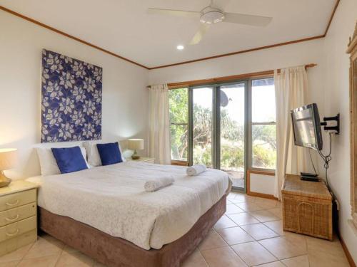 a bedroom with a large bed and a television at Claytons 1 in Point Lookout