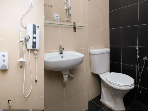 a bathroom with a toilet and a sink at TY Hotel in Kuala Terengganu