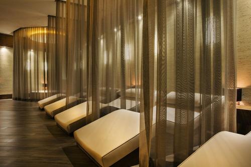 a row of white beds in a waiting room at Nirvana Mediterranean Excellence - Ultra All Inclusive in Beldibi