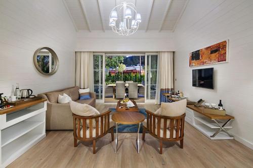 a living room with a table and a couch at Nirvana Mediterranean Excellence - Ultra All Inclusive in Beldibi