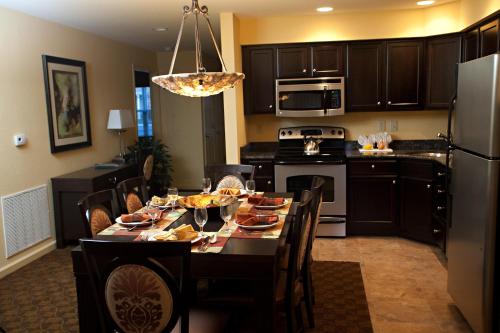 a kitchen with a table with chairs and a dining room at The Colonies at Williamsburg in Williamsburg