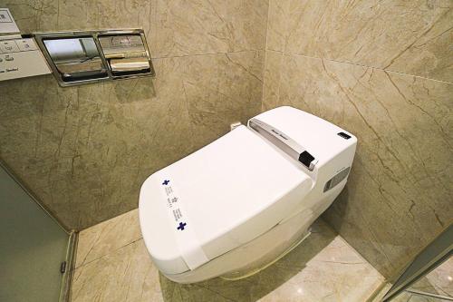 a bathroom with a white toilet in a stall at Guwol Hotel in Incheon