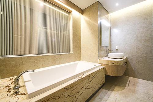 a bathroom with a tub and a sink at Guwol Hotel in Incheon