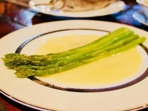 a white plate with asparagus on a table at Appi Life is Beautiful in Hachimantai