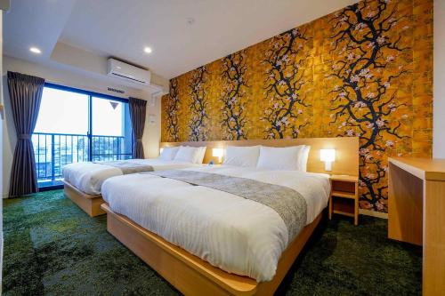 two beds in a hotel room with a wall mural at RESI STAY Gojozaka in Kyoto