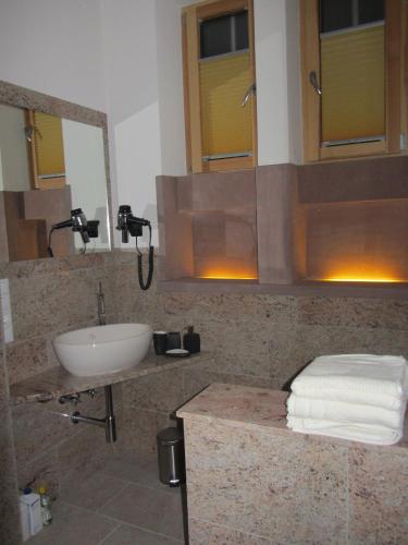 a bathroom with a sink and a mirror at Exklusive Gästezimmer Landau in Landau in der Pfalz