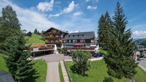 an aerial view of a large building with trees at Der Berghof in Hirschegg