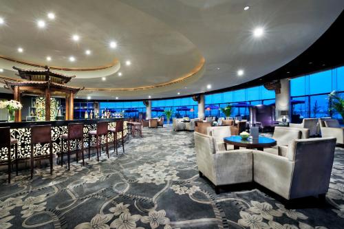 a hotel lobby with chairs and a bar at Jin Jiang International Hotel Xi'an in Xi'an