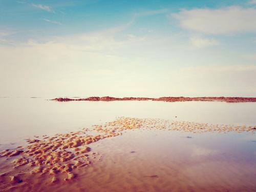 a view of a body of water with the shoreline at Hôtel Les Coutainvillaises in Agon Coutainville