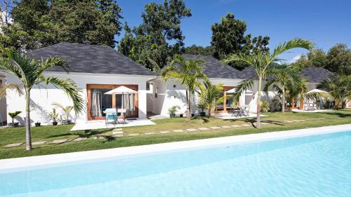 a house with a swimming pool in front of a house at Island World Panglao in Panglao