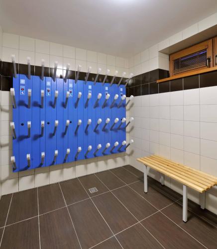 a locker room with blue lockers and a bench at Villa Gardenia in Donovaly