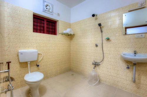 bagno con servizi igienici e lavandino di Three Roots Resort a Sultan Bathery