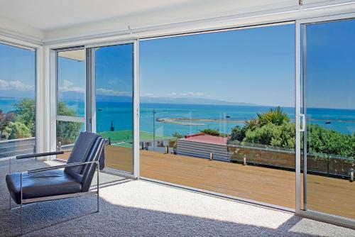 a living room with a view of the ocean at Above The Cut in Nelson