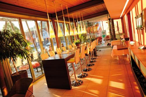 a dining room with a long table and chairs at Hotel-Restaurant-Café Krainer in Langenwang