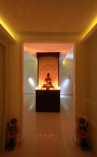 a room with a statue in a fireplace with lights at Vythiri Village in Vythiri